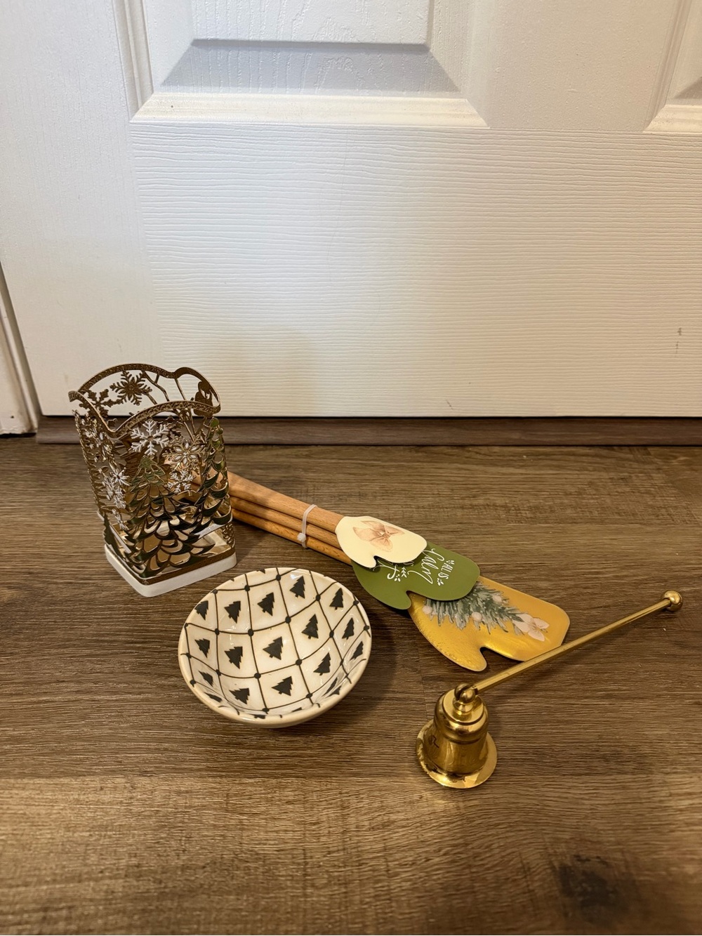 Bath & Body Works gold and cream holiday candle snuffer with decorative items